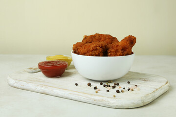 Concept of tasty eating with fried chicken on white textured table