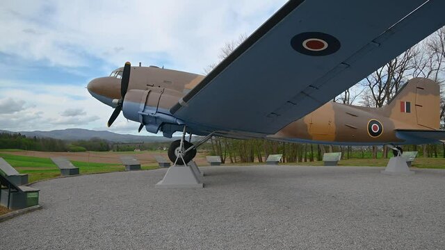Decommissioned aeroplane, a memorial to partizans and their help to Allied air forces during WWII. Aircraft exhibit in Slovenia. Wide angle, right pan