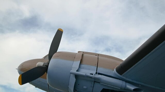 Close up view of decommissioned aero plane, a memorial to partisans and their help to Allied air forces during WWII. Aircraft exhibit in Slovenia. View under the airplane. Tilt down