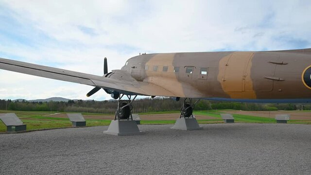 Decommissioned aeroplane, a memorial to partizans and their help to Allied air forces during WWII. Aircraft exhibit in Slovenia. Wide angle, right pan