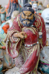 Abandoned ceramic statue photographed in Wah Kwai shrine in Aberdeen, Southern Hong Kong. In the old days, people didn't want to throw away the statues they'd had at and so the shrine was born.
