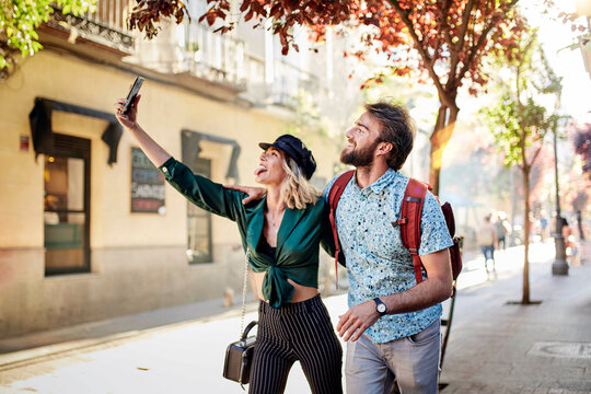 Cheerful Couple Doing Selfie While Standing Outdoors