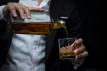 Closeup businessmen holding a glass of whiskey
