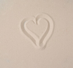 Heart drawn in sand. Summer beach concept.