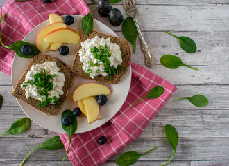 Healthy breakfast sandwich with fruits on a plate