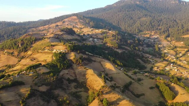 Drone Aerial Footage of mountains of El Rosario, Michoacan, Mexico during orange sunset