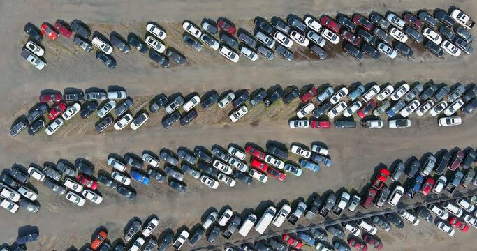 Aerial top view of the auction terminal parking lot a rows of used cars on distributed a parking