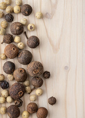 Peppers of different sizes and colors on  wooden table. Background and wallpaper, top view,...