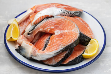 raw salmon with lemon in white dish