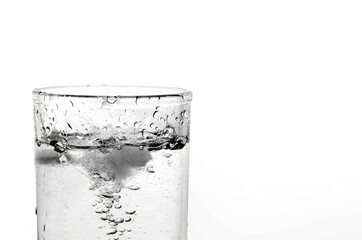 A glass of water and ice on a white background.