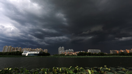 Urban architectural landscape shrouded by dark clouds, North China