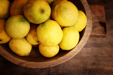 Image of group of fresh lemons over old vintage wooden table