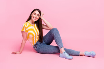 Full body profile side photo of young attractive cheerful girl happy positive smile sit floor isolated over pastel color background © deagreez