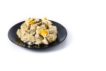 Potato salad with gherkins, egg and mustard isolated on white background
