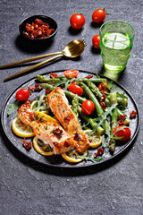 grilled salmon fillets with lemon, bacon,vegetables