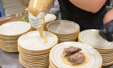 Elaboration of design dishes. Scenes of real teamwork by great Spanish professionals of gourmet haute cuisine for social events