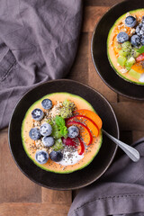 Fruit salad with yogurt in carved melon cantaloupe bowl