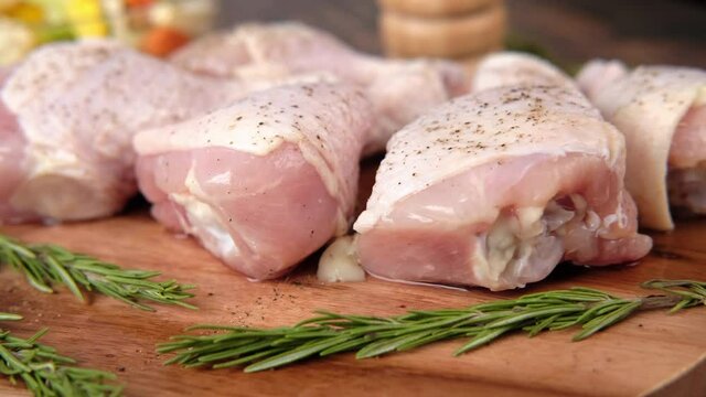  raw chicken drumstick on a chopping board 