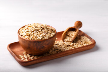 Oat flakes on white wooden background