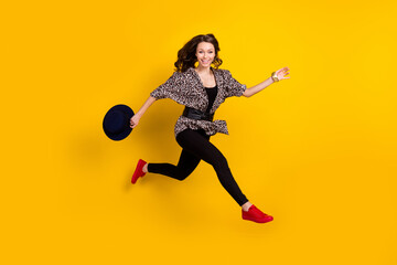 Full size profile side photo of active charming woman run jump up empty space sale isolated on yellow color background