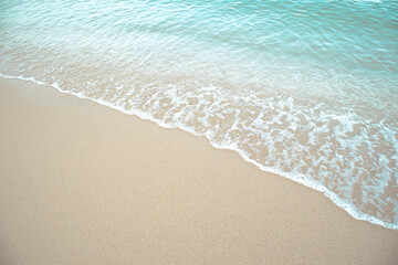 Fototapeta na wymiar Soft wave of blue ocean on sandy beach.Abstract Background,Thailand,Pattaya.