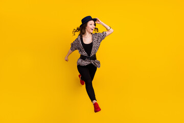 Fototapeta na wymiar Full length photo of charming young happy woman look empty space run jump isolated on yellow color background