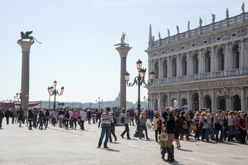 Tourists walk on the Piazza San Marco