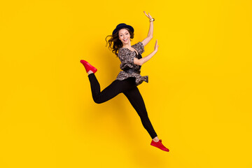 Fototapeta na wymiar Full length photo of stunning charming young woman jump up raise hands leg isolated on yellow color background