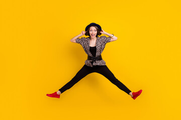 Fototapeta na wymiar Full length body size view of pretty funky cheerful girl jumping having fun fooling isolated over vivid yellow color background