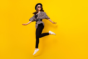 Fototapeta na wymiar Full length body size view of attractive fashionable cheerful girl jumping walking isolated over bright yellow color background