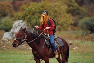 Foto op Canvas woman hiker riding a horse on nature mountains adventure © SHOTPRIME STUDIO