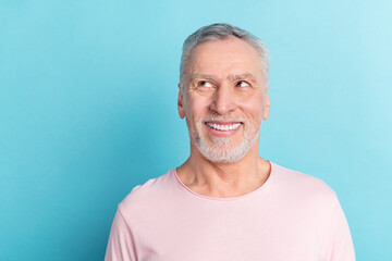 Photo portrait smiling man in pink t-shirt looking copyspace isolated on pastel blue color background © deagreez