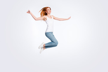 Fototapeta na wymiar Full body photo of funky cheerful red hairdo lady jump wear white top jeans isolated on bright color background