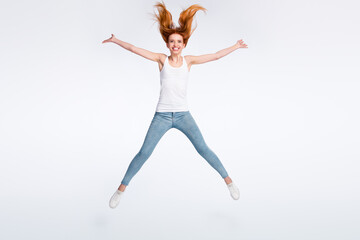 Obraz premium Full size photo of funny positive red hairdo lady jump wear white top jeans isolated on bright color background