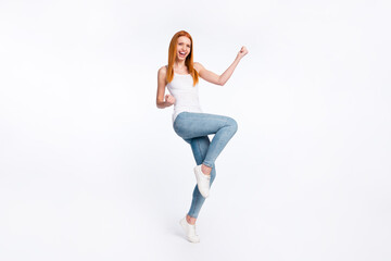 Fototapeta na wymiar Full size photo of hooray nice red hairdo lady hands fists wear white top jeans isolated on bright color background