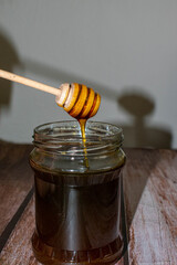 Wooden Honey Dipper Drizzling Honey