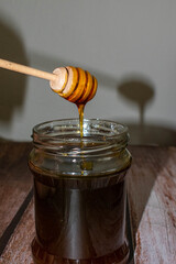 Wooden Honey Dipper Drizzling Honey