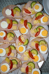 Traditional czech sandwich called "chleb&iacute;ček" with eggs, vegetable and ham.