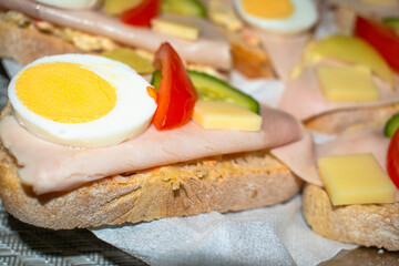 Traditional czech sandwich called "chleb&iacute;ček" with eggs, vegetable and ham.