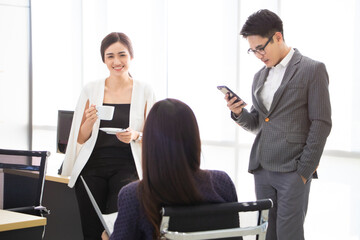 Fototapeta premium Asian young male and female have a casual and free style meeting, drinking coffee and checking information on phone.