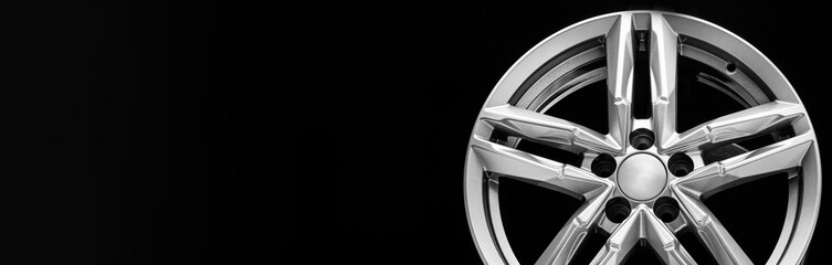 silver alloy wheel with bifurcated beams on a black background, copy space, long panoramic