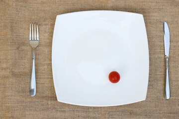 Fresh tomatoes in a plate on a dark background. Harvesting tomatoes. Top view