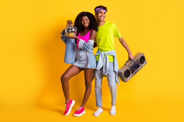 Full length body size view of handsome beautiful cheerful couple having fun deejay event isolated on bright yellow color background