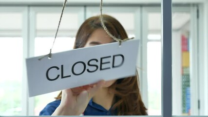 Woman hands turning sign board closed to open shop small local retail business. Happy Asian woman smiling face reopen shop again with service mind. Small owner turn sign plaboard welcome opening shop