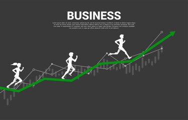Obraz premium Silhouette of businessman and businesswoman running on graph. business concept of success in business