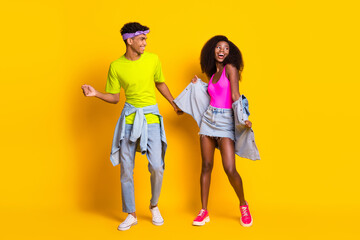 Naklejka premium Full length body size view of attractive cheerful couple dancing good mood isolated over bright yellow color background