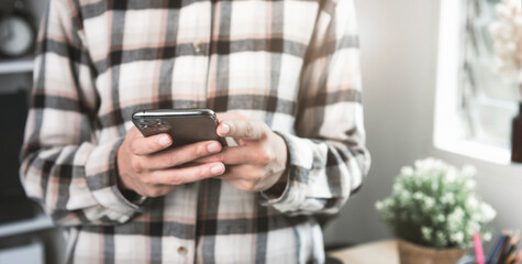Young casual Businesswoman holding and using smartphone for sms messages technology and Social media network concept.