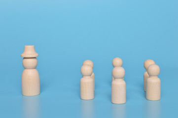 Wooden doll figures gathering community with their leader