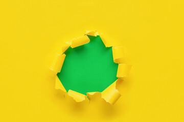 Hole in yellow paper with green background. Green Monday concept