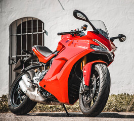 Naklejka na ściany i meble red motorcycle parked on a street
